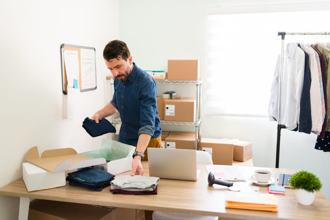 South African small-business owner packing online orders to ship to customers